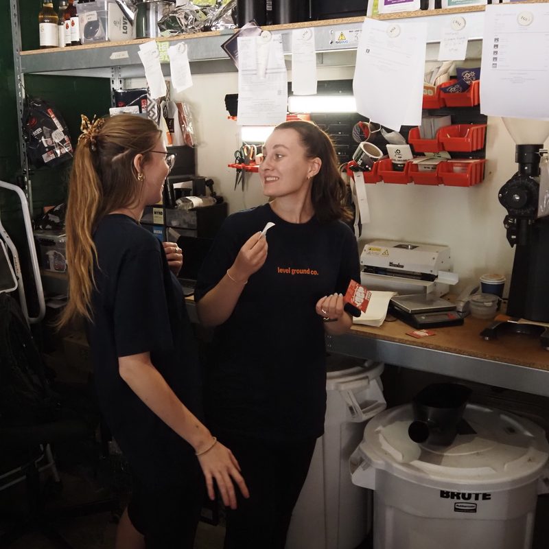Two team members tasting coffee in the roastery