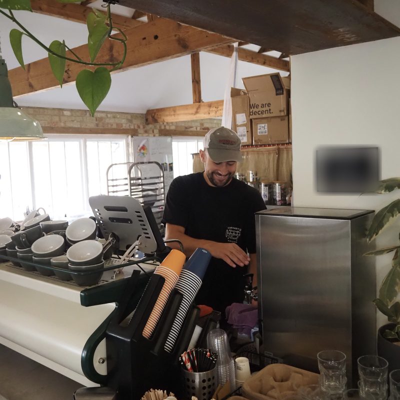 Barista smiling while working at the espresso machine