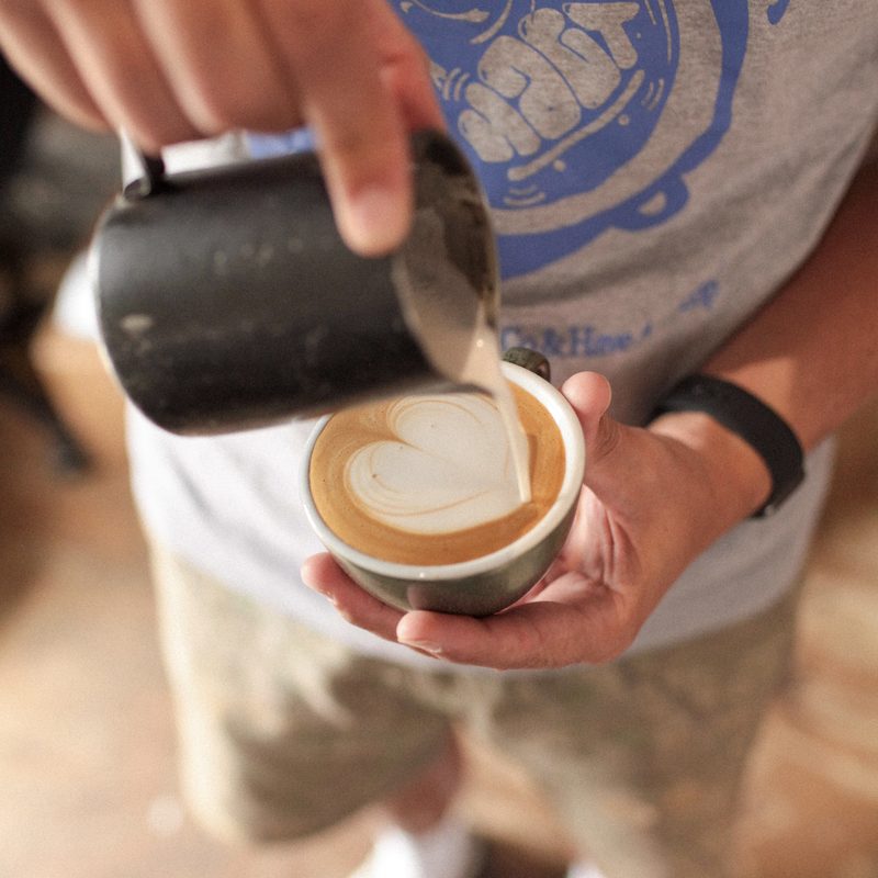 Latte art being poured into a cup