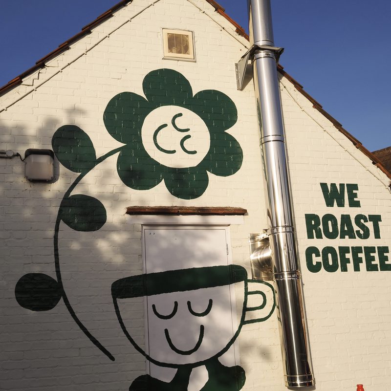 We Roast Coffee mural on the roastery wall