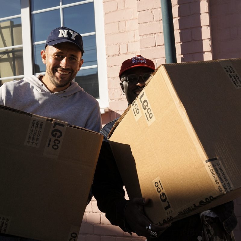 Two team members carrying LGco boxes